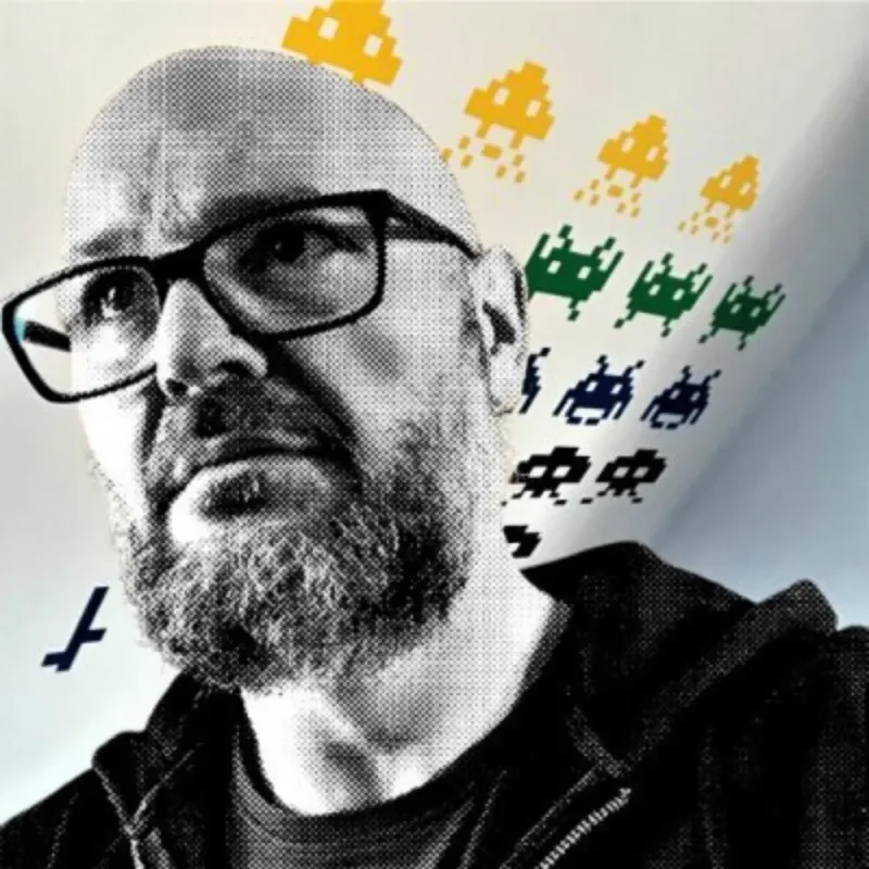 Christian A. Dumais in glasses and a dark hoodie, a halftone portrait with pixel space invaders behind him