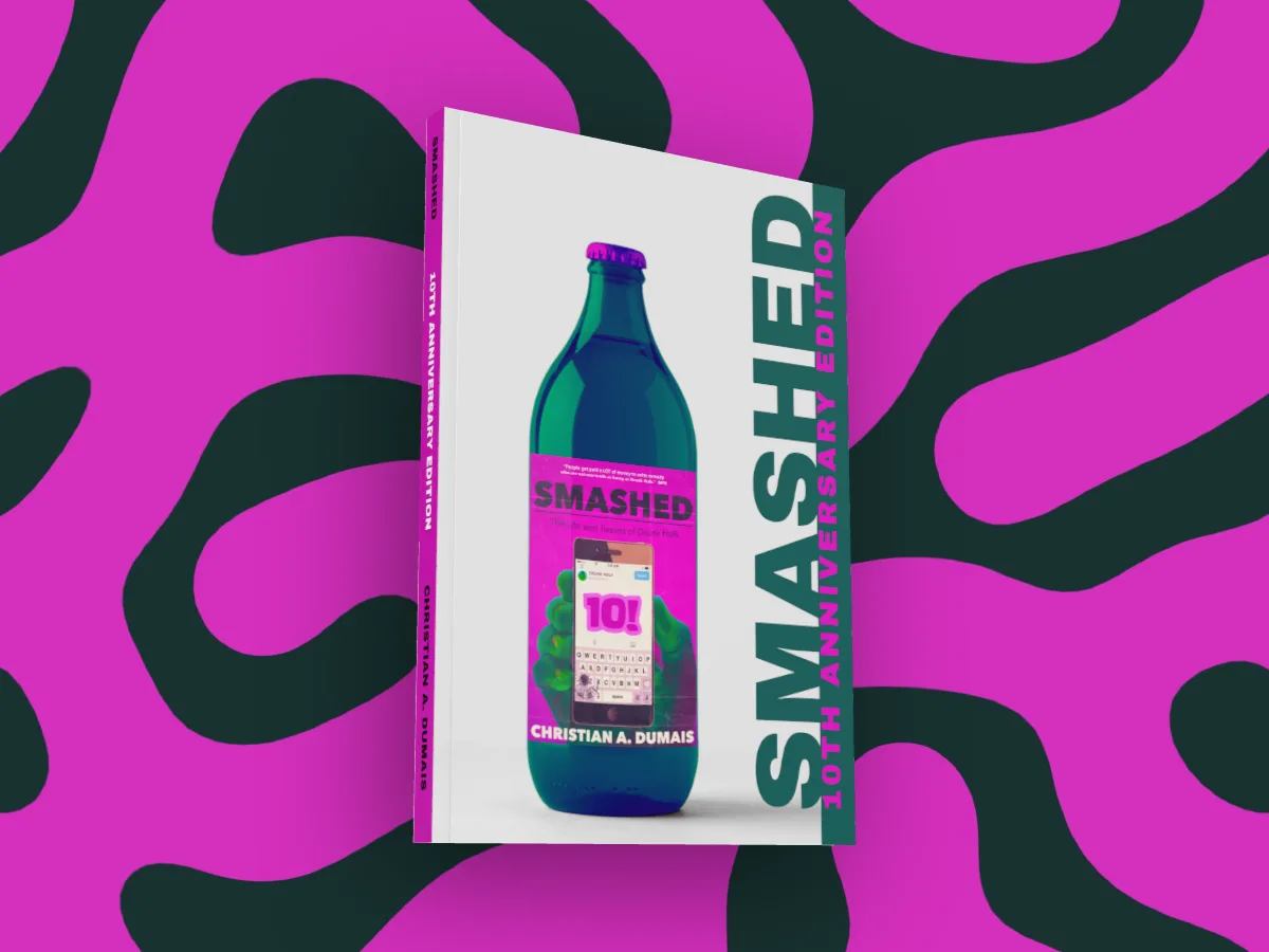 Smashed by Christian A. Dumais as a glossy 3D paperback, turned to show its white spine, on a teal and magenta coral pattern