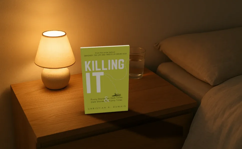 Killing It standing on a bedside table beside a lamp, at 970 by 600
