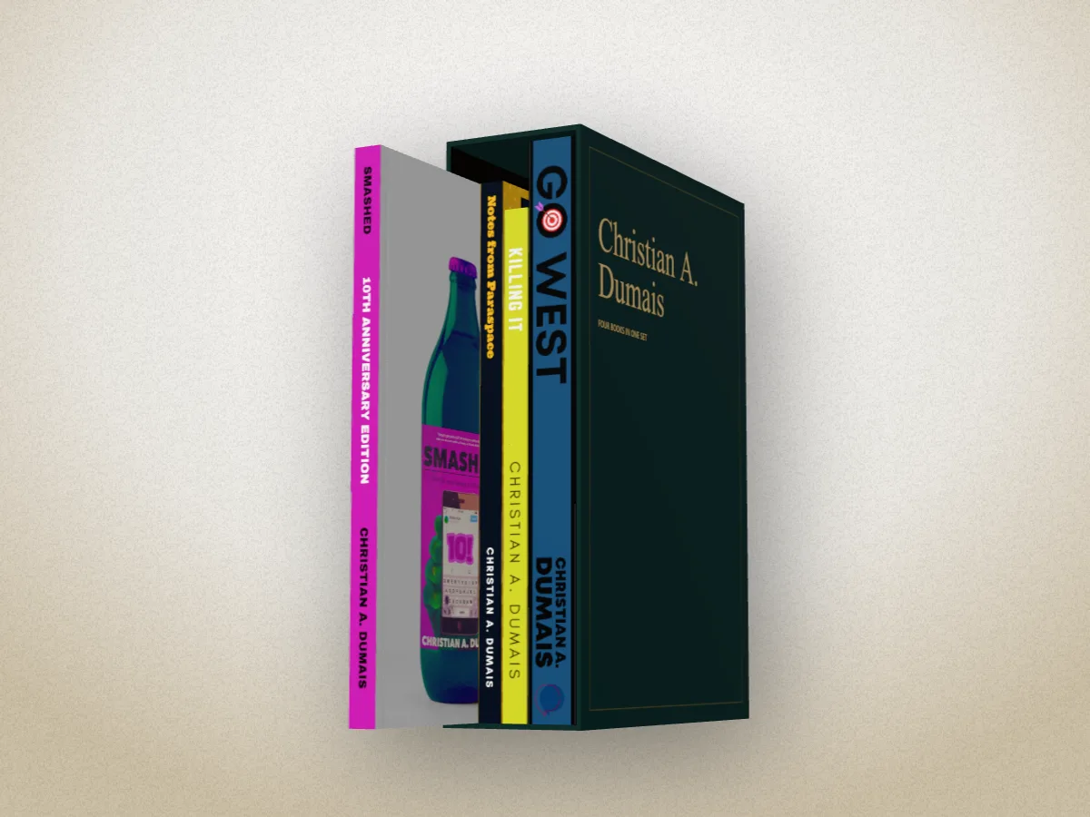 Four of Christian A. Dumais's books in a dark green slipcase with his name on it, Smashed pulled half out