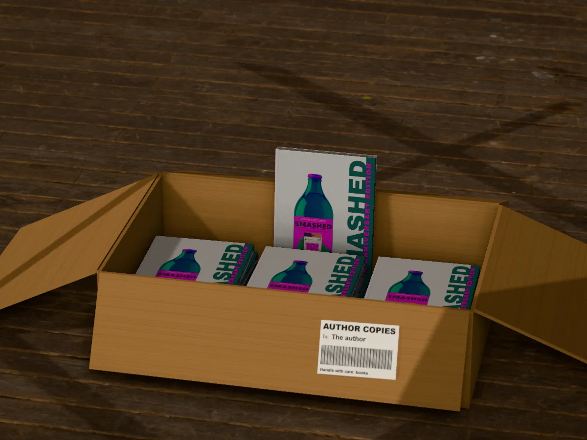 An opened cardboard box of Smashed by Christian A. Dumais on a wooden floor, three copies flat inside and one standing at the back, a parcel label on the front